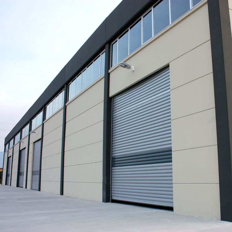 A commercial warehouse in Jacksonville, FL, with multiple roller doors and a large window
