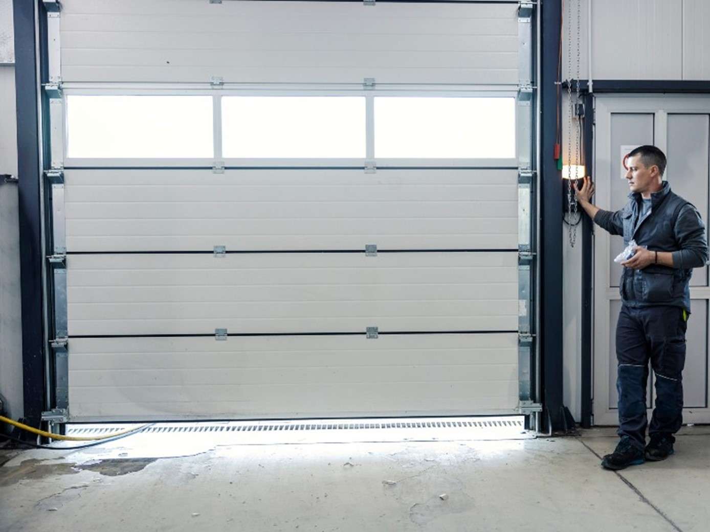 A professional is installing a garage door at a commercial area in Jacksonville, FL