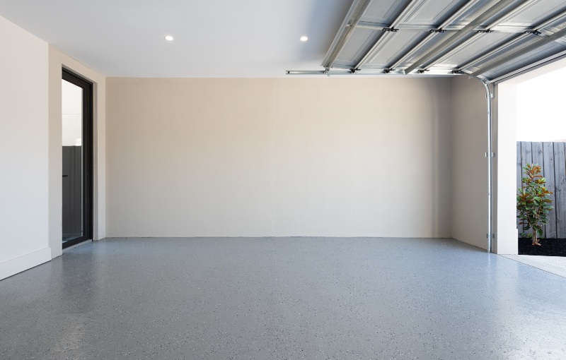 Clean empty residential garage interior with open garage door in Jacksonville, FL