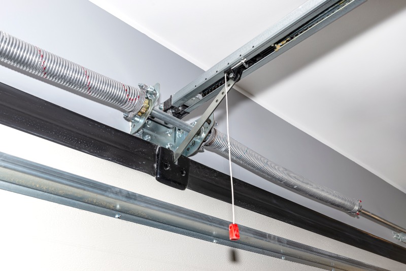Garage door spring and opener rail system installed on ceiling in Jacksonville, FL