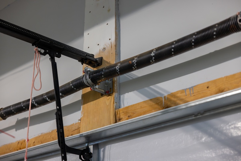 Garage door torsion spring and hardware system mounted above door in Jacksonville, FL