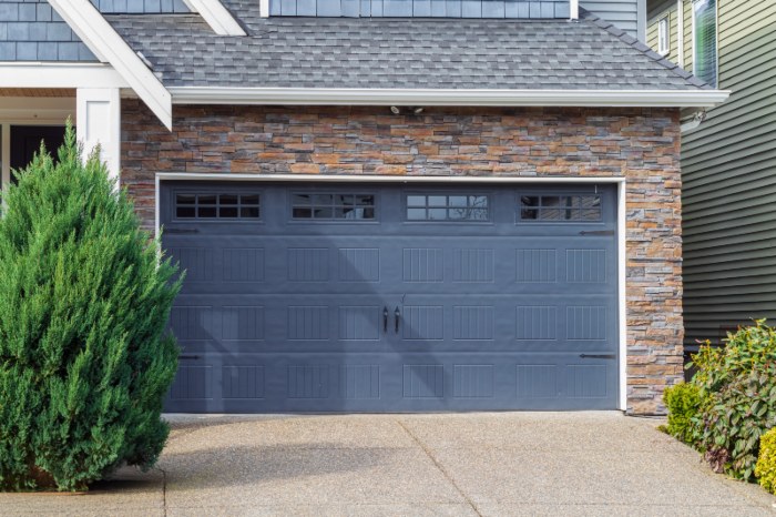Hand using a remote to open the residential garage door in Jacksonville, FL