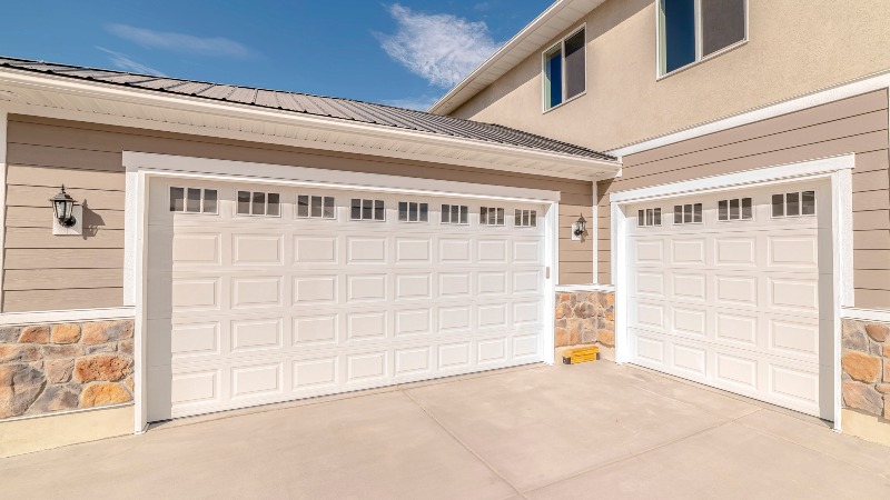 Hand using a remote to open the residential garage door in Jacksonville, FL