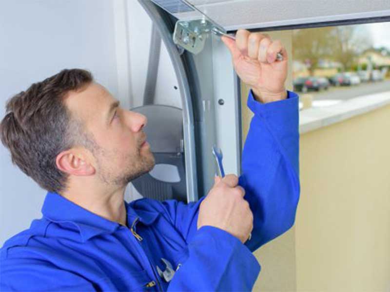 man fixing garage doors