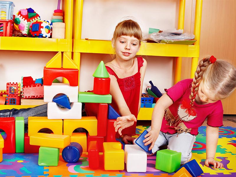 Two small girl playing with a toys