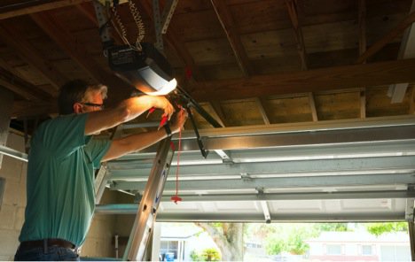 men fixing broken garage door track