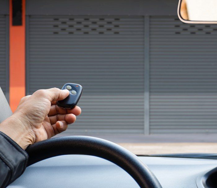 Man Opening Garage Door with a remote